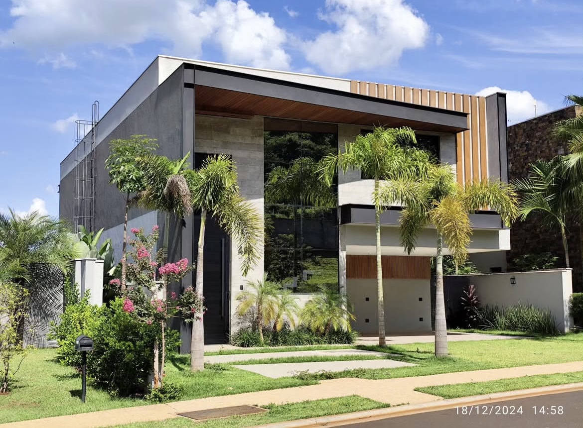 Fachada contemporânea da Residência Lavanda com volumes em concreto, brises de madeira e paisagismo tropical